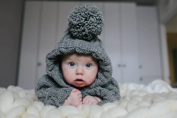 Small baby in knitted clothes