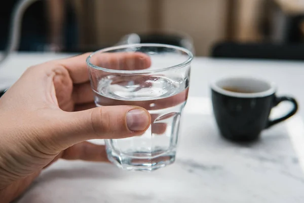 Glass of water in hand — Stock Photo, Image