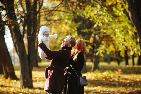 Ung familj och nyfödde son i höst park — Stockfoto