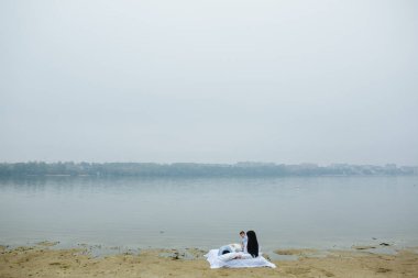 Mutlu genç aile gölde birlikte dinleniyor.