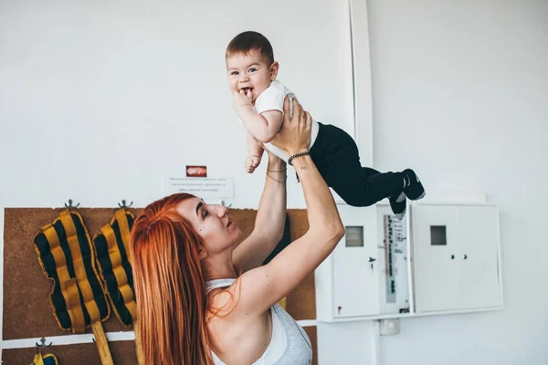 Joven madre con su hijo pequeño en el gimnasio —  Fotos de Stock
