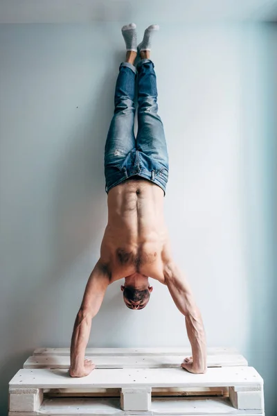 Hombre posando en cámara, de pie boca abajo — Foto de Stock