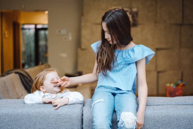 Büyük ve küçük kızı büyük koltukta.