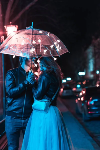 Erkek ve kız şemsiyenin altında öpüşüyor. — Stok fotoğraf
