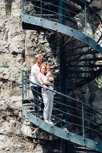 The family standing on a spiral staircase — Stock Photo, Image