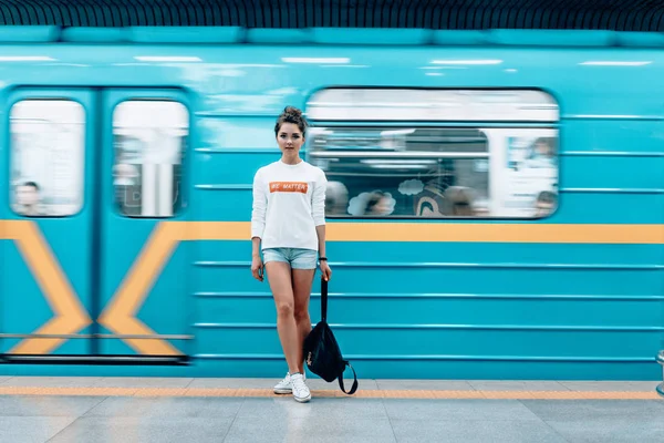 Metro istasyonunda poz veren güzel genç kız.