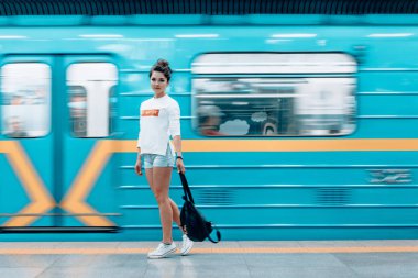 Metro istasyonunda poz veren güzel genç kız.