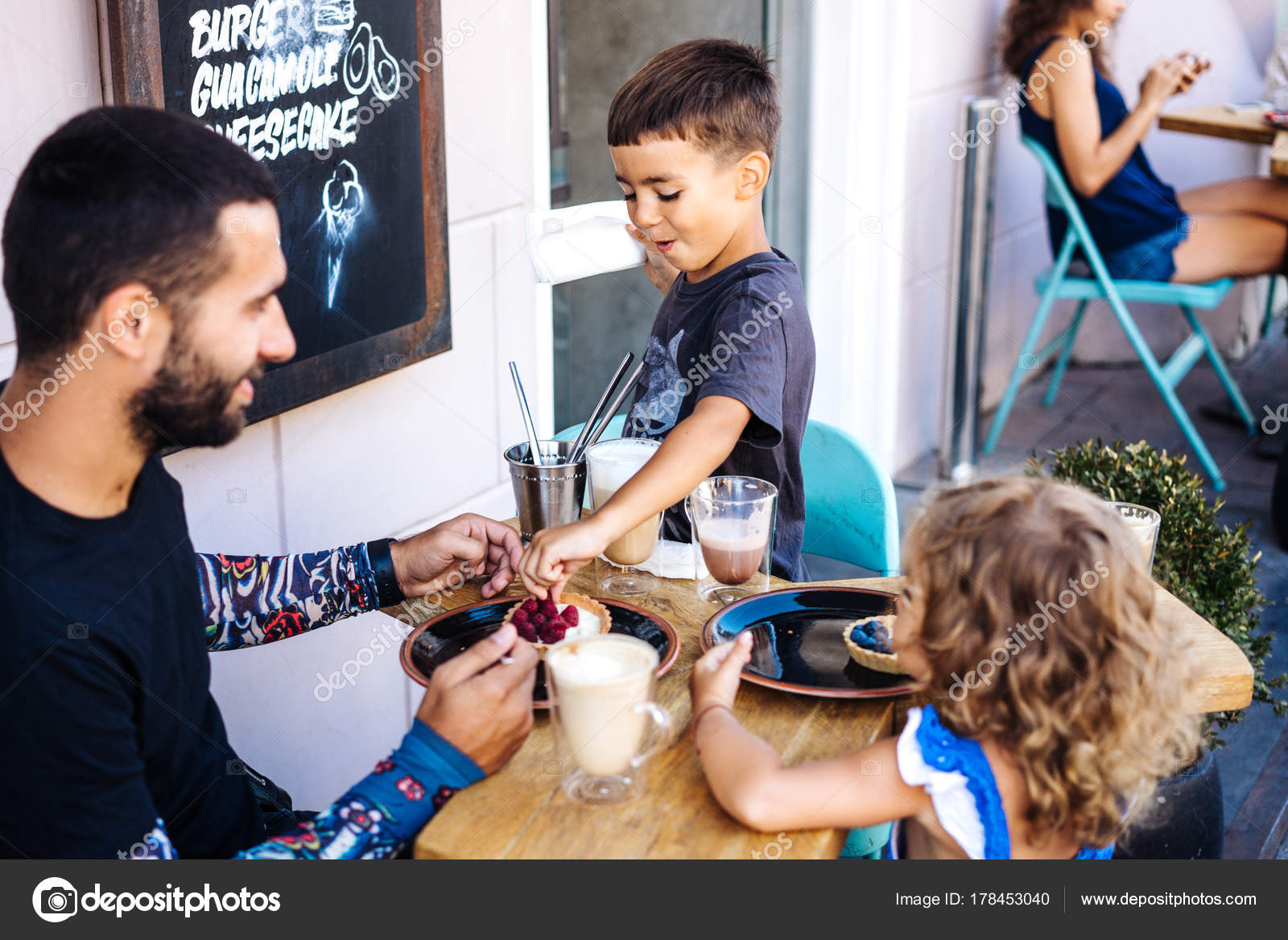 Dad Daughter And Son Are Eating Dessert Stock Photo C Simbiothy 178453040
