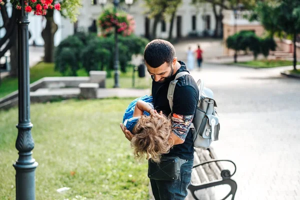 Cute little girl in her fathers arm — Stock Photo, Image