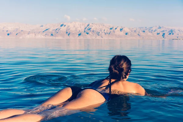 Meisje is ontspannen en zwemmen in het water — Stockfoto