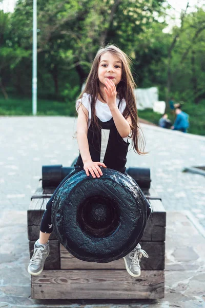 Дошкільна дівчина сидить на гарматі — стокове фото