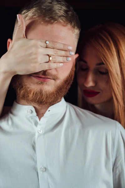 Close up of woman covering boyriends eyes with hands. — Stock Photo, Image