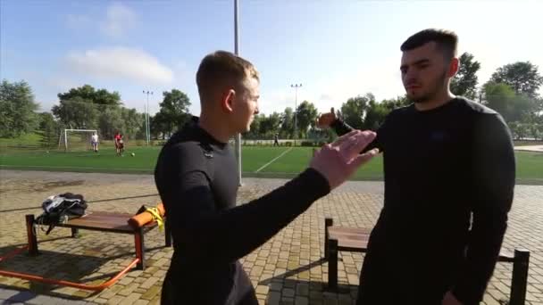 Two guys high five on the sports ground — Stock Video