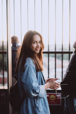 Modaya uygun mavi kot ceket giymiş çekici, duygusal bir kızın portresi.