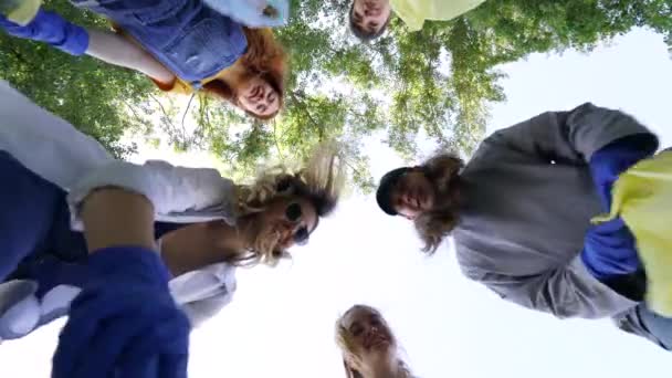 Group of activists friends throw a lot of garbage in a bag. Bottom-up shooting — 비디오