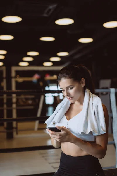 Dívka píše, když si dává pauzu v tělocvičně. Čte zprávu — Stock fotografie