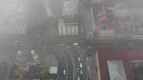 A city covered in fog. City traffic, aerial view