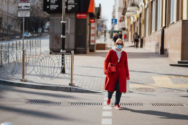 Kiev, Ukraine, March 28, 2020, Ukrainian people at facial protective masks at almost empty street, quarantine time at Ukraine, clipart