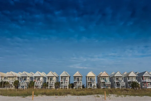 Ciel bleu avec une rangée de maisons de plage — Photo
