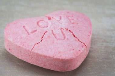 Close Up of Cracked Love U Candy Heart clipart