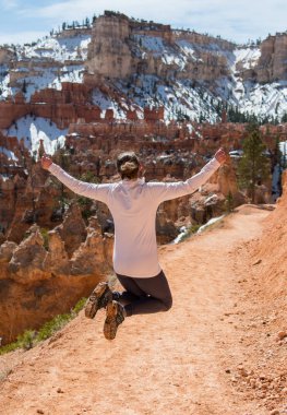 Silhouette of a Woman Jumping Over Dirt Trail clipart