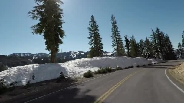 Curvy Road Through Snowy Mountain en un día soleado — Vídeo de stock