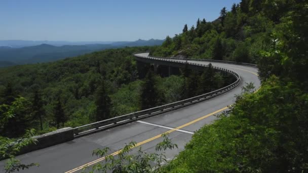 Motorcycle Crosses Linn Cove Away from Camera — Stock Video