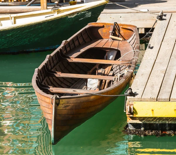 Старая лодка, привязанная к причалу — стоковое фото