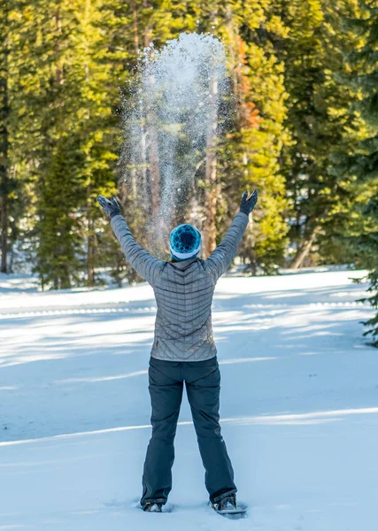 Snow Falls on Woman in Utah Forest
