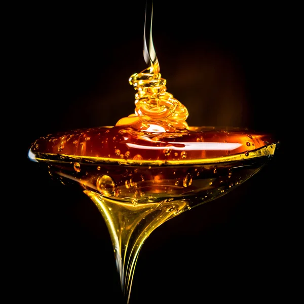 stock image Abstract of Honey Pouring Into Spoon