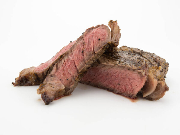 Steak slices from a ribeye isolated on a white background