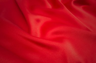 Arkaplan olarak kırmızı saten veya ipek kumaş