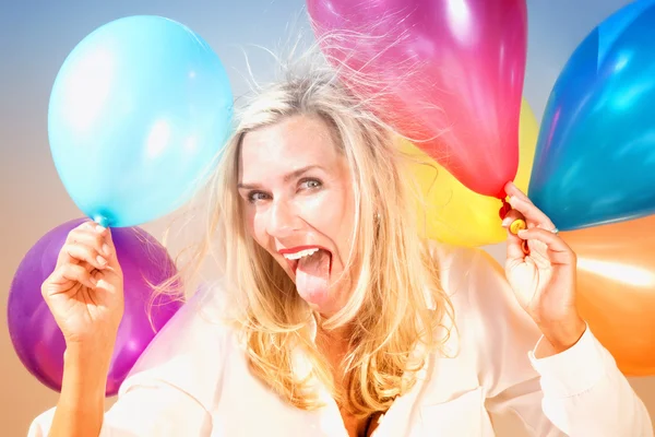 Funny portrait of blond woman with balloons — Stock Photo, Image