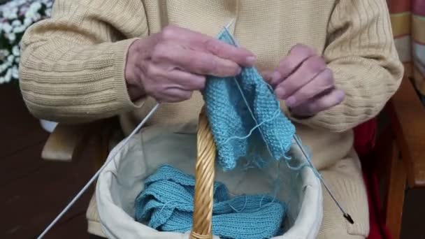 Closeup of older woman knitting a scarf — Stock Video