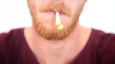 Genç Kızıl saçlı sakallı adam ortak bir sigara closeup