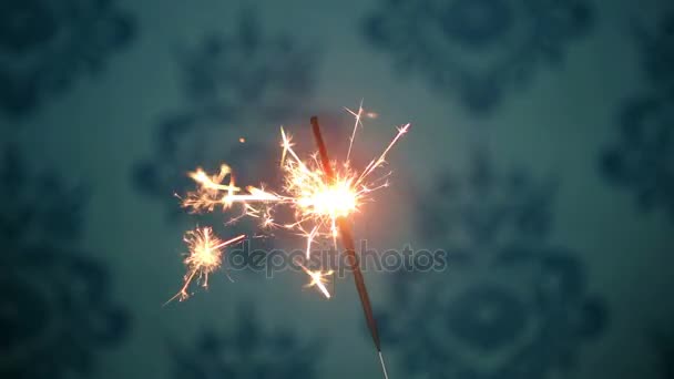 One sparkler shining bright with blue background — Stock Video