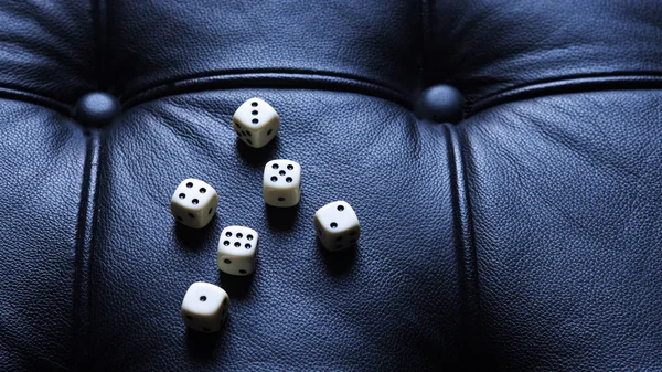 Six dice lying on black leather — Stock Photo, Image