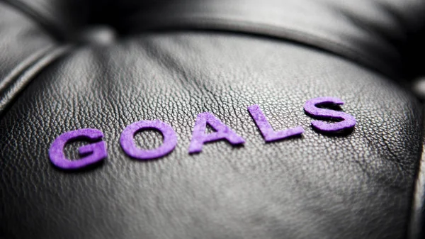 The word goals on black leather — Stock Photo, Image