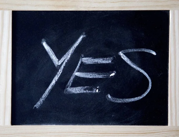 Yes written on a black chalk board — Stock Photo, Image