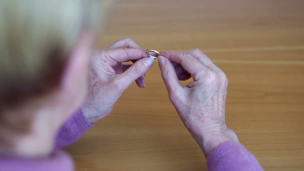 Closeup of older woman hands putting ring on her finger — Stock Video