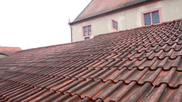 Closeup of an old medieval cobblestone road and red roof with tiling — Stock Video