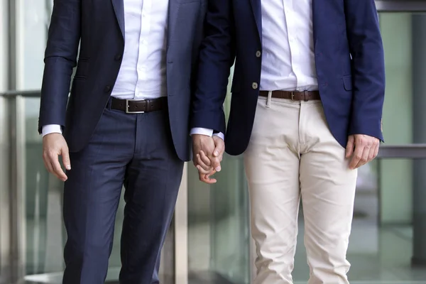 Two men in suits holding hands — Stock Photo, Image