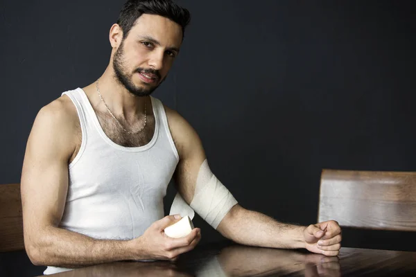 Portrait of handsome man with bandage at his arm — Stock Photo, Image