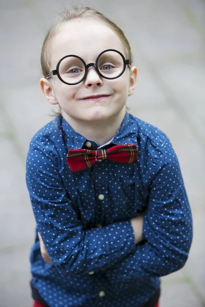 Blond boy with bow tie and big glasses — Stock Photo, Image