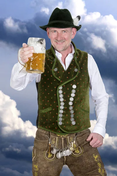 Bavarian man holding a mug of beer — Stock Photo, Image