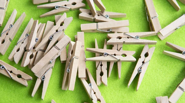 Wooden clothespins on a green background — Stock Photo, Image