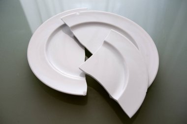 white broken plate on glass table clipart