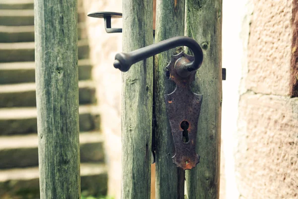 Cerca de madeira velha com maçaneta da porta — Fotografia de Stock