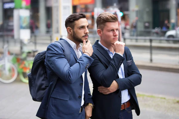 Zwei Geschäftsleute stehen auf der Straße und schauen sich etwas an — Stockfoto