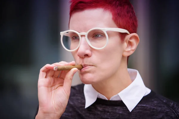 Portrait of red-haired woman smoking a cigar — Stock Photo, Image